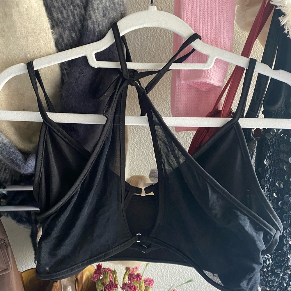 Black crop top with intricate detailing.